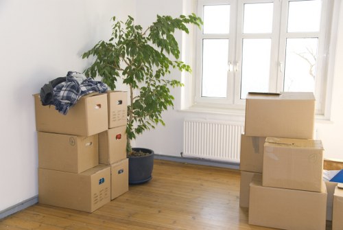 Packed office furniture and labelled boxes ready for relocation